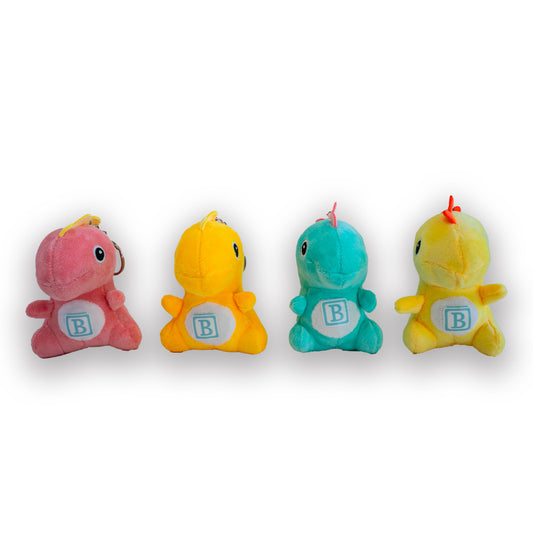 A set of four plush dinosaur keychains in different colors, each with a 'B' on its back, displayed in a row.